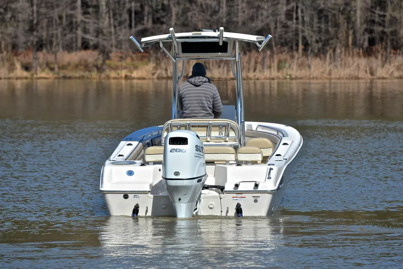 Slide: The Image of 2022 Sea Chaser 22 HFC boat on calm water, rear view with outboard motor. - 8