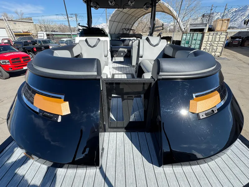 Slide: The Image of 2025 Montara 25' SURF BOSS 2.0 SL boat with sleek black design and spacious seating. - 13