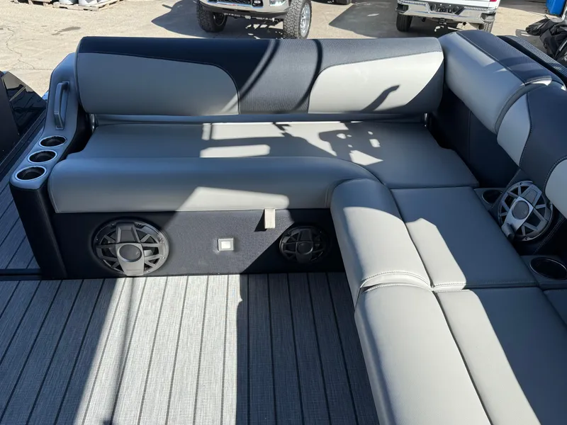 Slide: The Image of 2025 Montara 25' SURF BOSS 2.0 SL boat interior with gray seating and built-in speakers. - 17