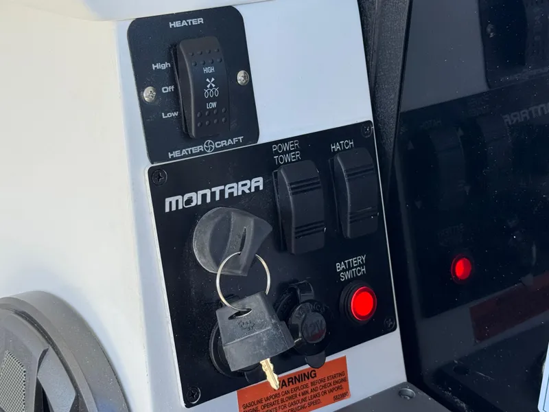 Slide: The Image of Control panel of 2025 Montara 25' SURF BOSS 2.0 SL with key and switches. - 23