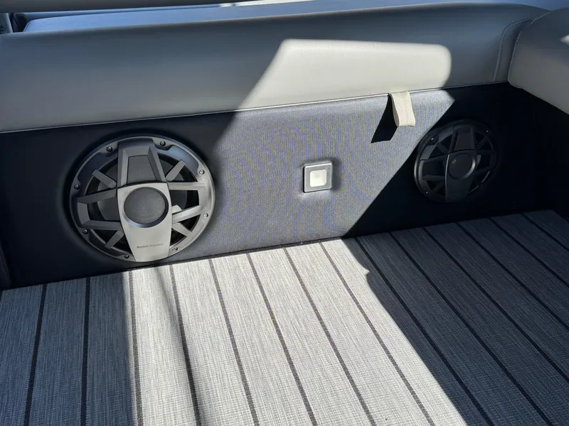 Slide: The Image of 2025 Montara 25' SURF BOSS 2.0 SL boat interior with speakers and striped flooring. - 24