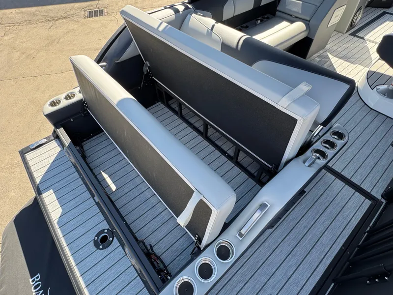 Slide: The Image of 2025 Montara 25' SURF BOSS 2.0 SL boat interior with adjustable seating and cup holders. - 29