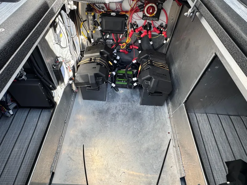 Slide: The Image of 2025 Montara 25' SURF BOSS 2.0 SL engine compartment with wiring and battery setup. - 31