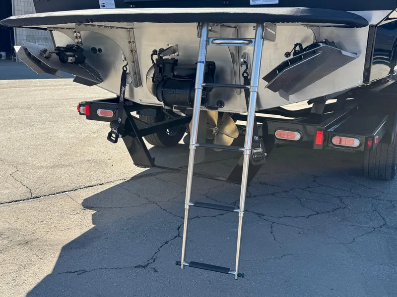 Slide: The Image of 2025 Montara 25' SURF BOSS 2.0 SL boat with ladder and trailer. - 5