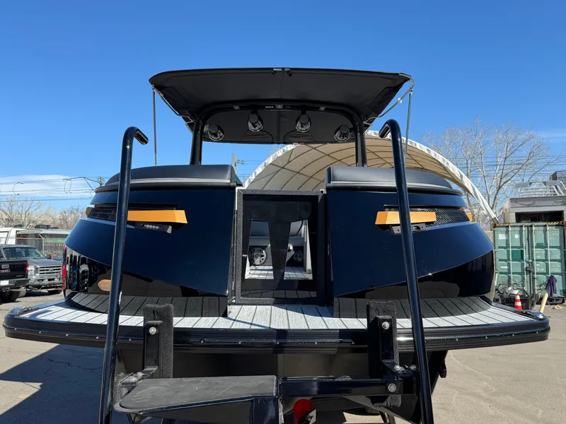 Slide: The Image of 2025 Montara 25' SURF BOSS 2.0 SL boat, rear view, sleek black design. - 9
