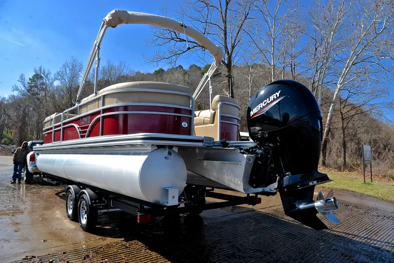 Slide: The Image of 2021 Lowe SS250 pontoon boat with Mercury engine on a trailer by a lakeside. - 12