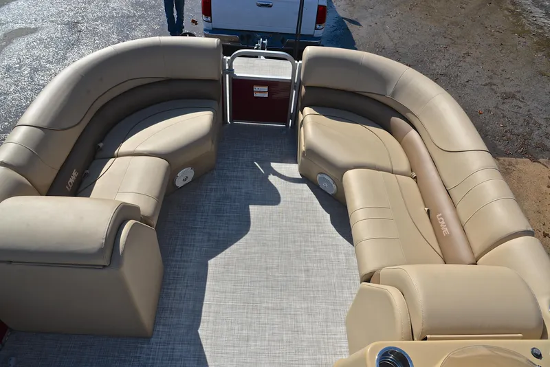 Slide: The Image of 2021 Lowe SS250 pontoon boat interior with beige seating and spacious layout. - 22