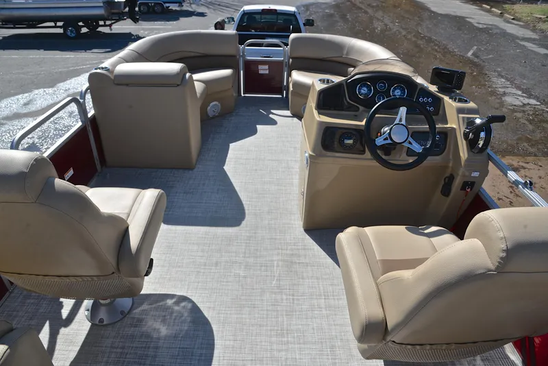 Slide: The Image of 2021 Lowe SS250 pontoon boat interior with beige seating and steering console. - 25