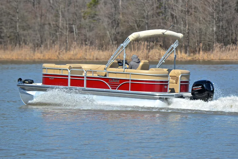 Slide: The Image of 2021 Lowe SS250 pontoon boat cruising on a lake with trees in the background. - 4