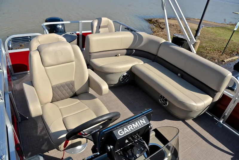 Slide: The Image of 2024 Sun Tracker BASS BUGGY 18 interior with beige seating and Garmin navigation. - 24