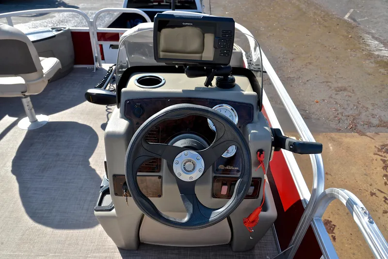 Slide: The Image of 2024 Sun Tracker BASS BUGGY 18 boat console with steering wheel and navigation system. - 26