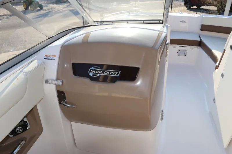 Slide: The Image of 2018 Chaparral 230 Suncoast boat interior with Suncoast logo and seating area. - 12