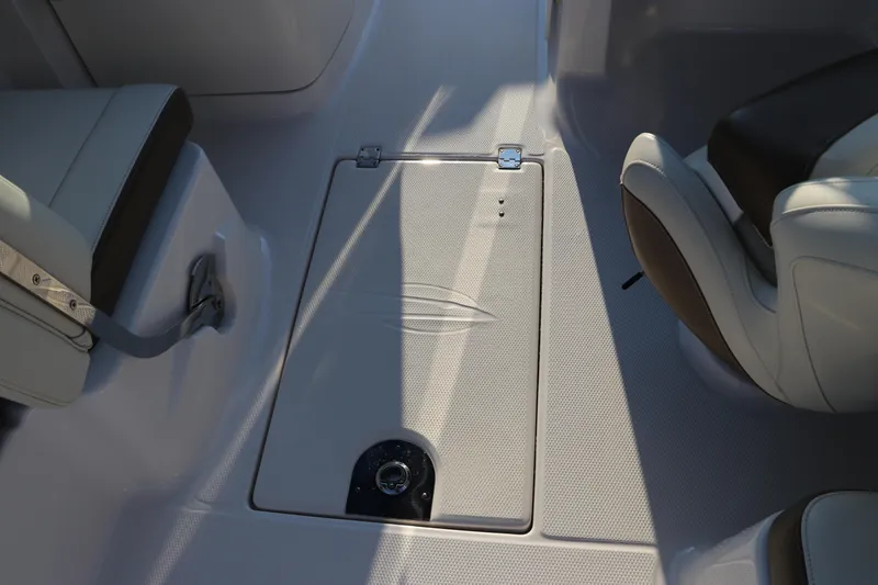 Slide: The Image of Interior view of 2018 Chaparral 230 Suncoast boat, featuring seating and storage compartment. - 15