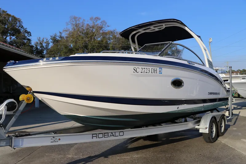 Slide: The Image of 2018 Chaparral 230 Suncoast boat on trailer, side view, outdoors. - 2