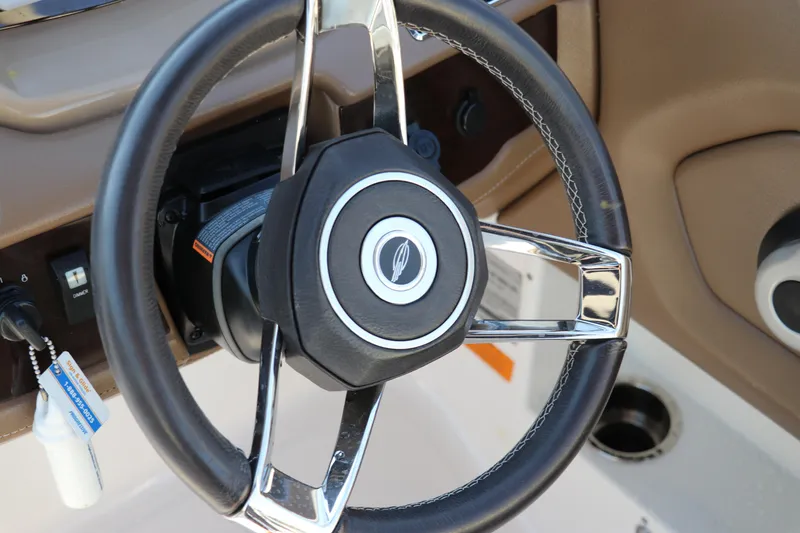 Slide: The Image of Steering wheel of 2018 Chaparral 230 Suncoast boat, featuring sleek chrome accents. - 20