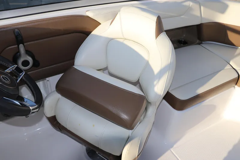 Slide: The Image of 2018 Chaparral 230 Suncoast boat interior with brown and white seating. - 21