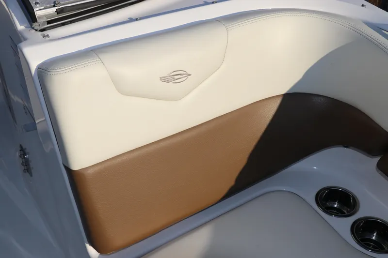 Slide: The Image of 2018 Chaparral 230 Suncoast boat interior with beige and brown seating. - 24