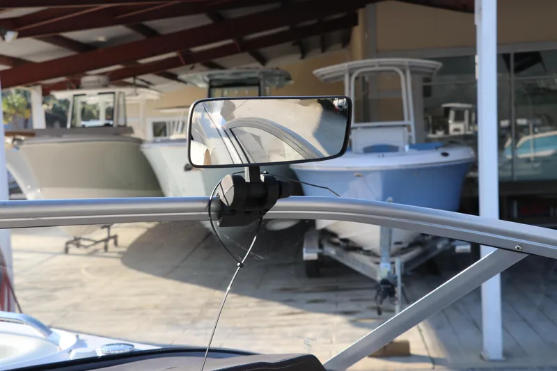 Slide: The Image of 2018 Chaparral 230 Suncoast boat with rearview mirror, docked in a marina. - 26
