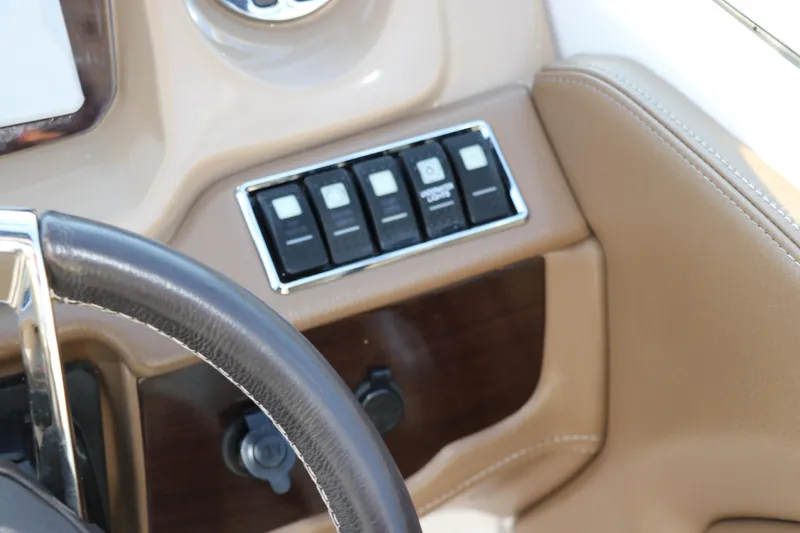 Slide: The Image of Dashboard controls of 2018 Chaparral 230 Suncoast boat with leather steering wheel. - 28