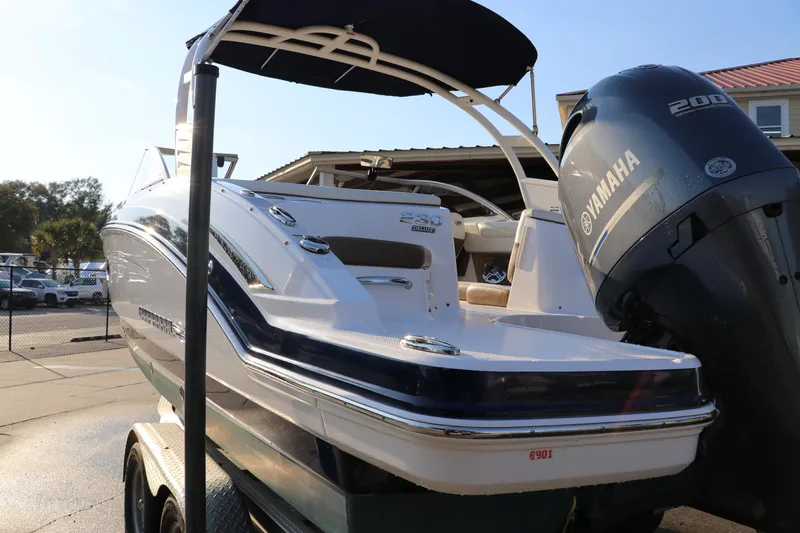 Slide: The Image of 2018 Chaparral 230 Suncoast boat with Yamaha engine, parked on a trailer. - 3