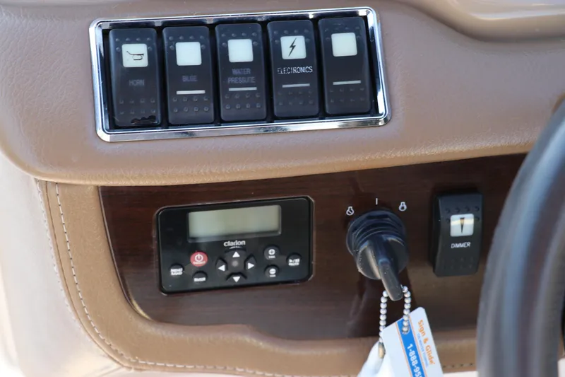 Slide: The Image of Control panel of 2018 Chaparral 230 Suncoast boat with switches and audio system. - 30