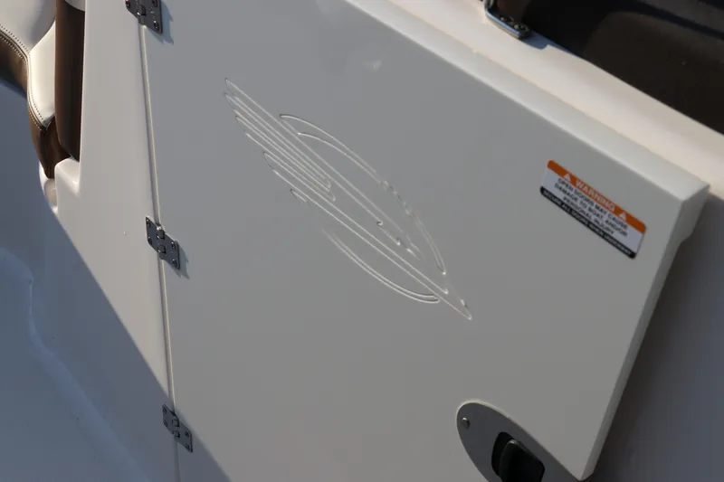 Slide: The Image of 2018 Chaparral 230 Suncoast boat compartment with embossed logo and safety label. - 32