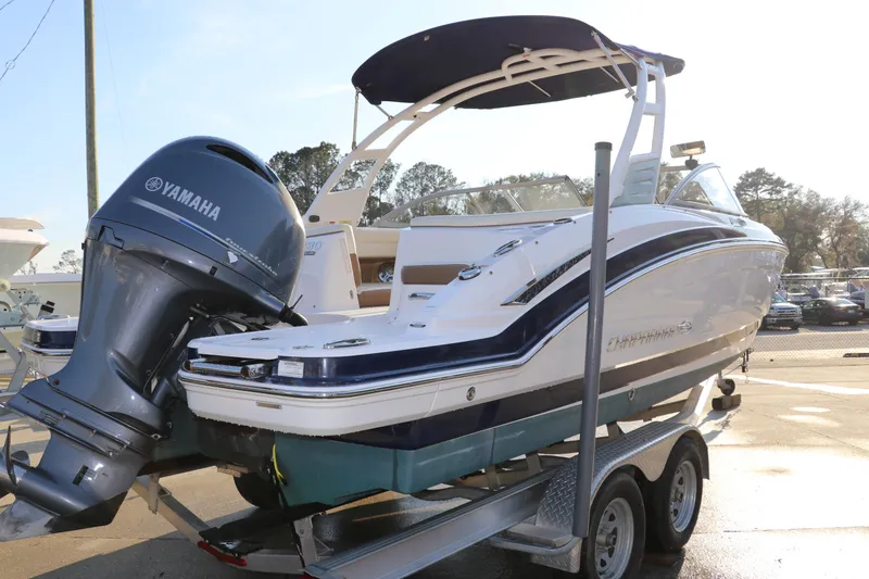 Slide: The Image of 2018 Chaparral 230 Suncoast boat with Yamaha engine on trailer, outdoor setting. - 4
