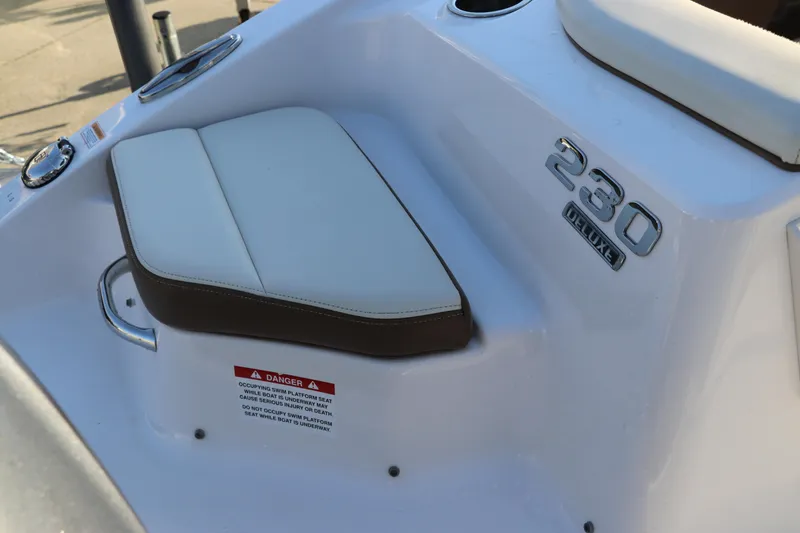 Slide: The Image of 2018 Chaparral 230 Suncoast boat seat detail with model emblem. - 7