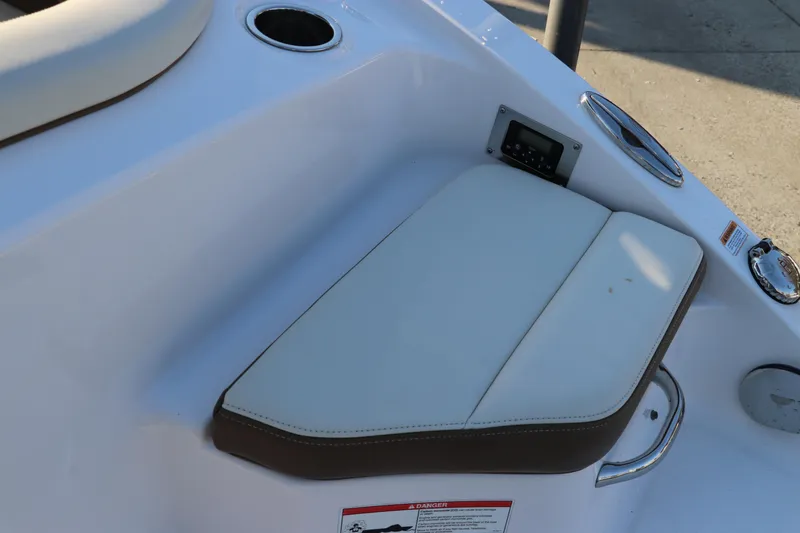 Slide: The Image of 2018 Chaparral 230 Suncoast boat seat with cup holders and control panel. - 8