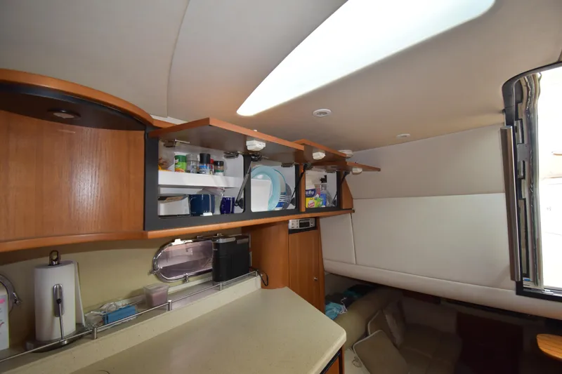 Slide: The Image of 2008 Tiara Yachts 39 Sovran interior with open cabinets and cozy seating area. - 7