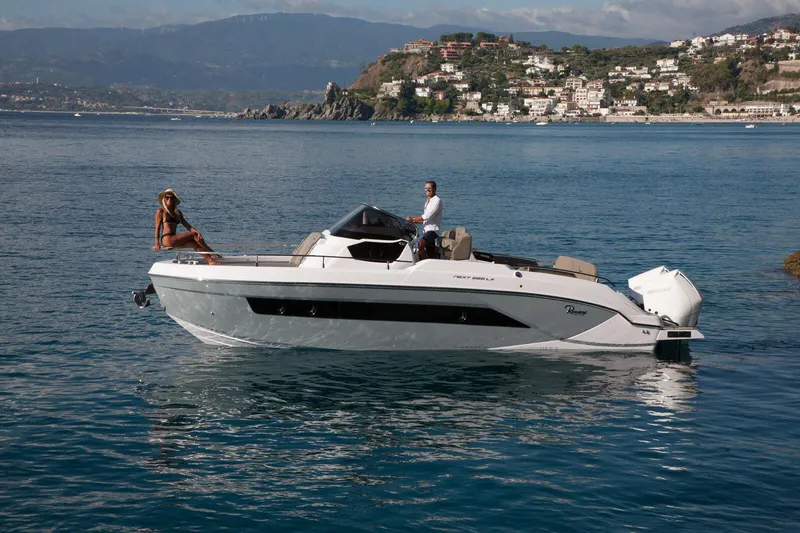 Slide: The Image of 2025 Ranieri NEXT 285 XL boat cruising on scenic coastal waters. - 11