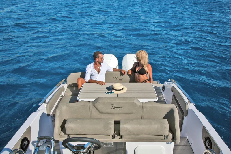 Slide: The Image of Couple relaxing on a 2025 Ranieri NEXT 285 XL boat in open water. - 18