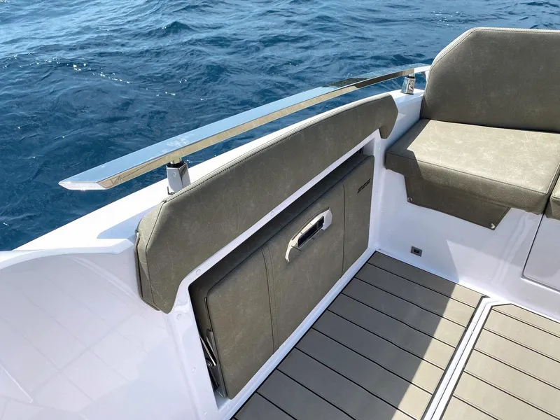 Slide: The Image of 2025 Ranieri NEXT 285 XL boat interior with cushioned seating and ocean view. - 19