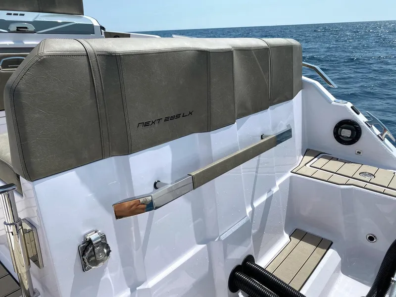 Slide: The Image of 2025 Ranieri NEXT 285 XL boat interior, featuring sleek seating and modern design on open water. - 25