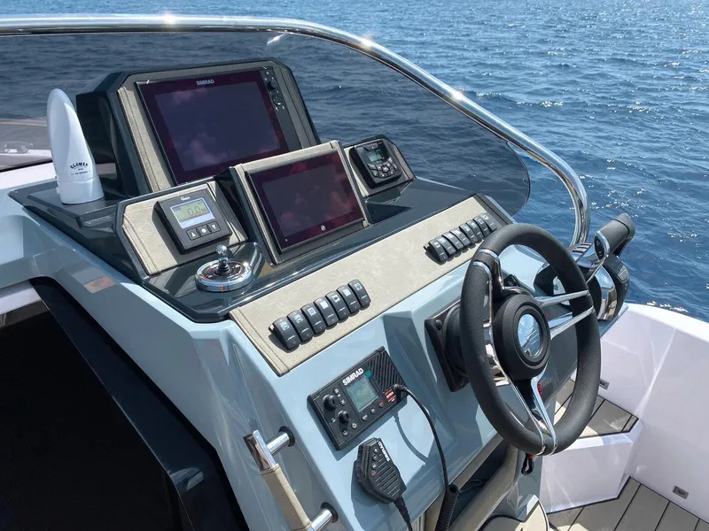 Slide: The Image of 2025 Ranieri NEXT 285 XL boat dashboard with navigation screens and steering wheel. - 27