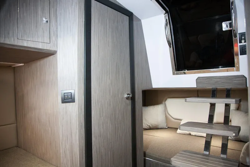 Slide: The Image of Interior of 2025 Ranieri NEXT 285 XL boat, featuring modern wood paneling and cozy seating. - 30
