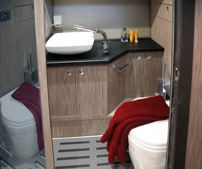Slide: The Image of Luxurious bathroom in 2025 Ranieri NEXT 285 XL boat with modern fixtures and red towel. - 32
