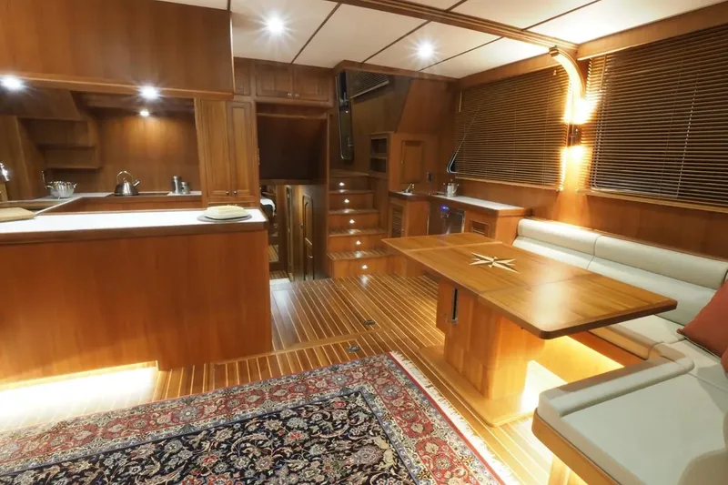 Slide: The Image of Luxurious interior of 2025 Helmsman Trawlers 46 Pilothouse with wood finishes and elegant seating. - 15