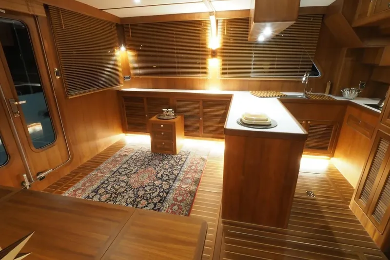 Slide: The Image of Luxurious interior of 2025 Helmsman Trawlers 46 Pilothouse with elegant wood finish and ambient lighting. - 18