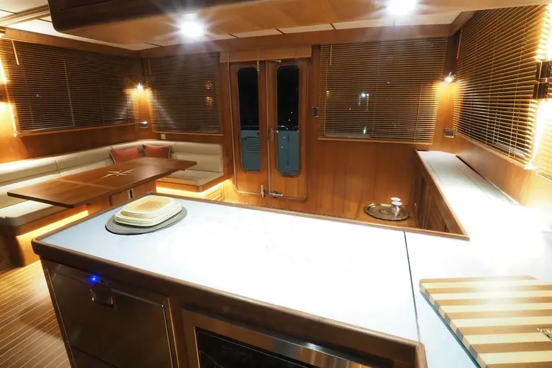 Slide: The Image of Luxurious interior of 2025 Helmsman Trawlers 46 Pilothouse with wood finishes and modern lighting. - 20
