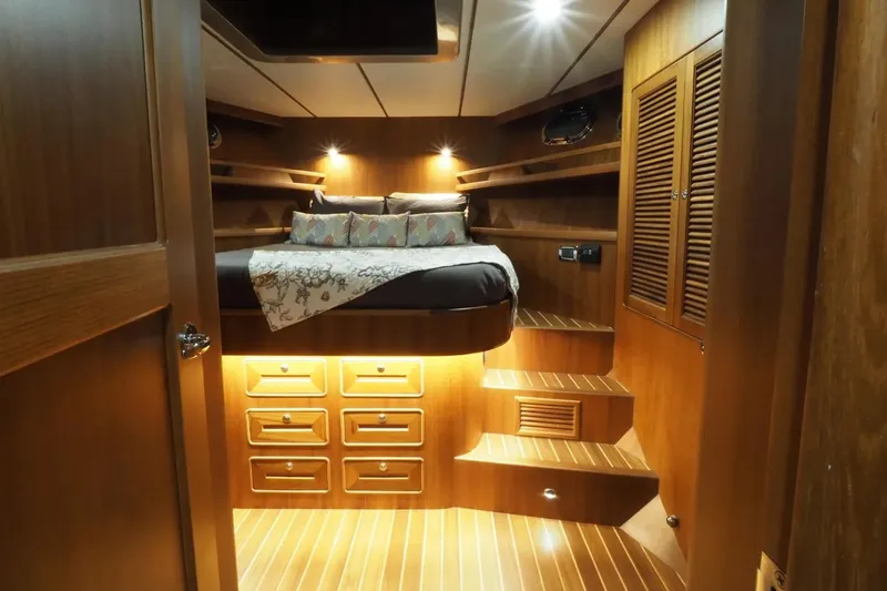 Slide: The Image of Luxurious cabin interior of 2025 Helmsman Trawlers 46 Pilothouse with wood finish and ambient lighting. - 26