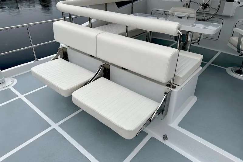 Slide: The Image of Helmsman Trawlers 46 Pilothouse 2025, featuring comfortable outdoor seating on deck. - 5