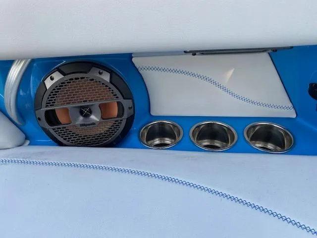 Slide: The Image of 2022 MasterCraft XT22 interior with speaker and cup holders, featuring blue and white design. - 22