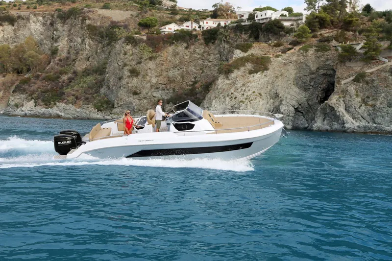 The Image of 2025 Ranieri NEXT 330 XL boat cruising near rocky coastline. - 0