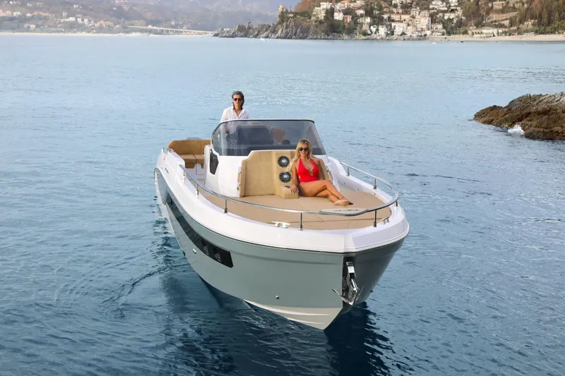 Slide: The Image of 2025 Ranieri NEXT 330 XL boat cruising on serene waters with passengers. - 5