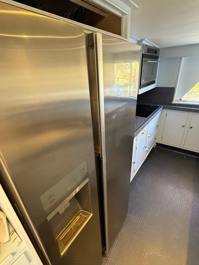 Slide: The Image of Stainless steel refrigerator in a modern kitchen aboard a 1972 Burger 81 Raised Pilothouse yacht. - 10