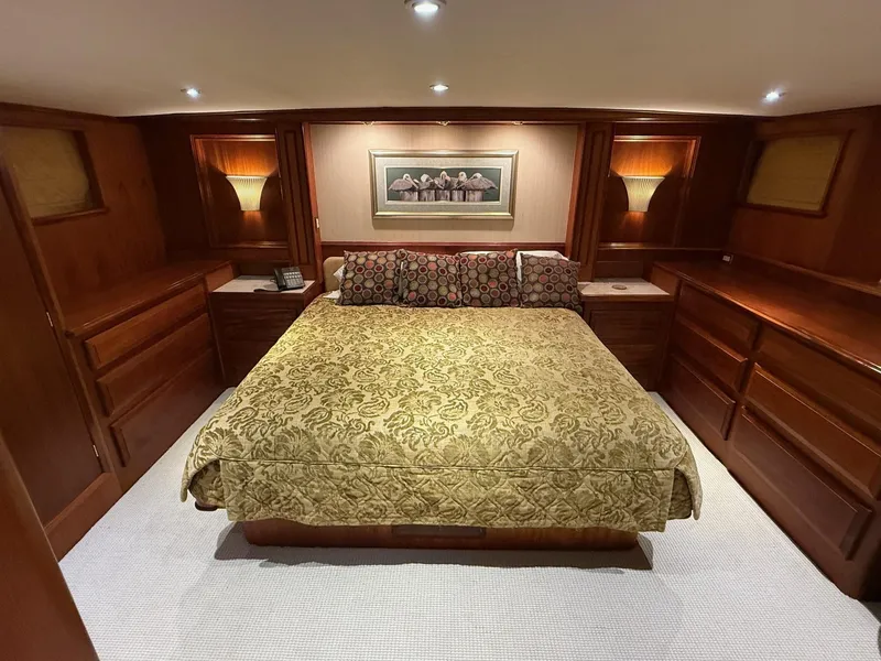 Slide: The Image of Luxurious bedroom in 1972 Burger 81 Raised Pilothouse yacht with elegant wood furnishings. - 11