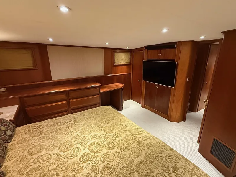 Slide: The Image of Luxurious interior of 1972 Burger 81 Raised Pilothouse yacht with wood paneling and elegant bedding. - 12