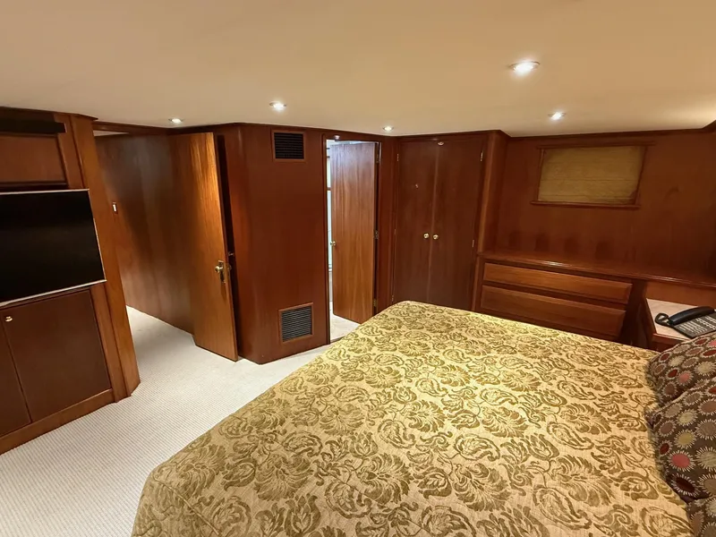 Slide: The Image of Luxurious 1972 Burger 81 Raised Pilothouse yacht bedroom with elegant wood paneling. - 13