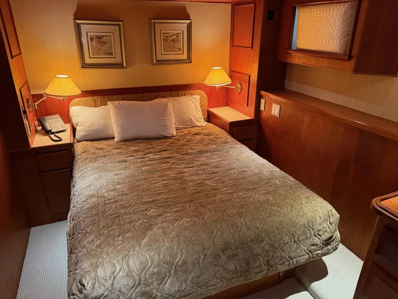 Slide: The Image of Cozy bedroom interior on 1972 Burger 81 Raised Pilothouse yacht with warm lighting. - 17